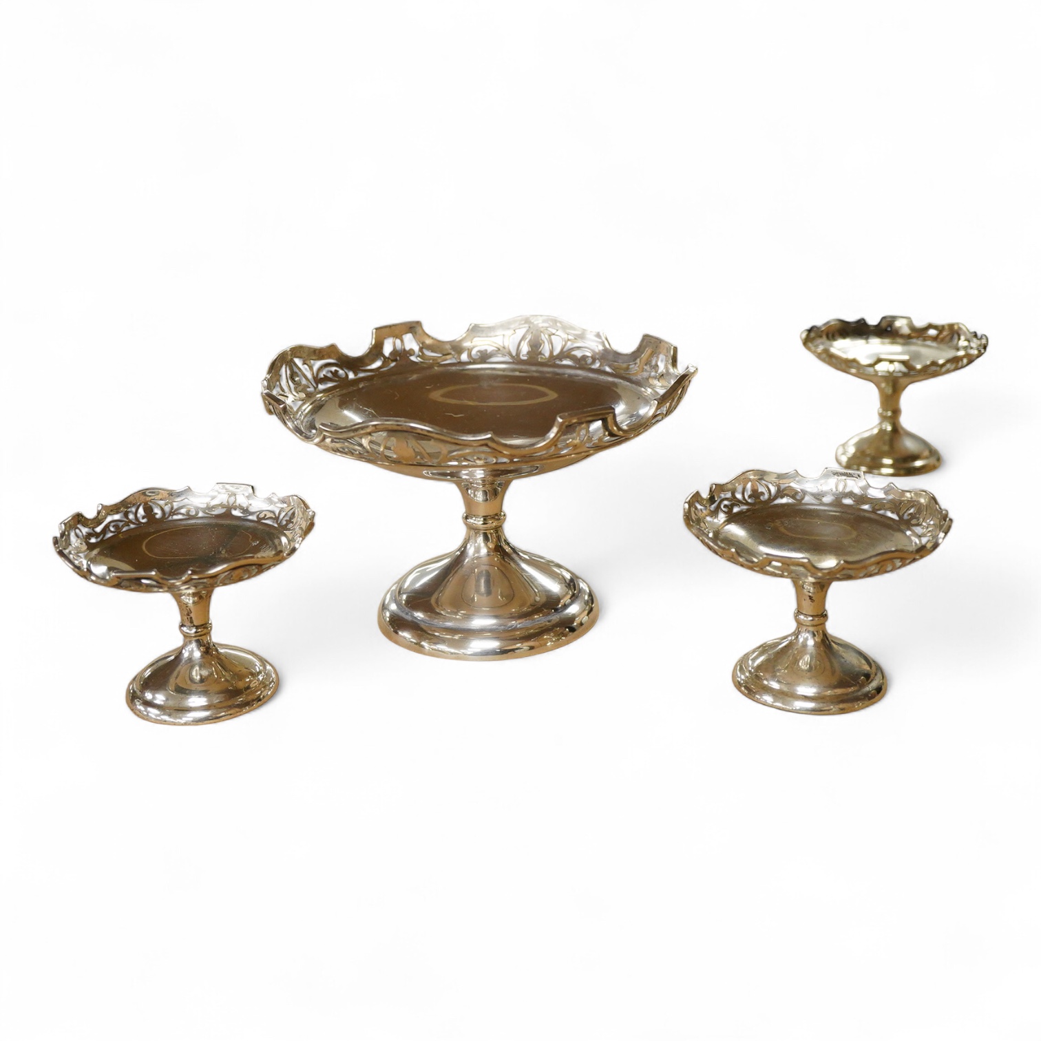 A suite of three George V graduated comports, by Stuart Dawson & Co Ltd, London, 1911, with pierced borders, comprising a large comport height 11.9cm and pair of smaller comports, height 7.2cm, 20oz.